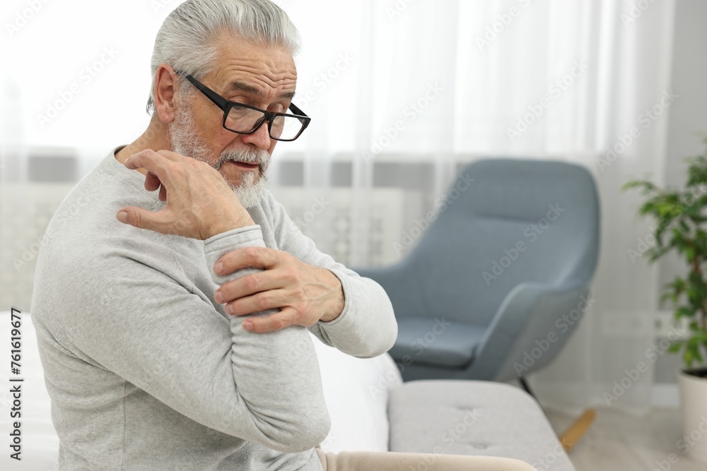 Arthritis symptoms. Man suffering from pain in hand at home Arthritis symptoms. Man suffering from pain in hand at home