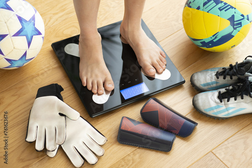 Kid or child feet on a weight scale concept suggesting being active