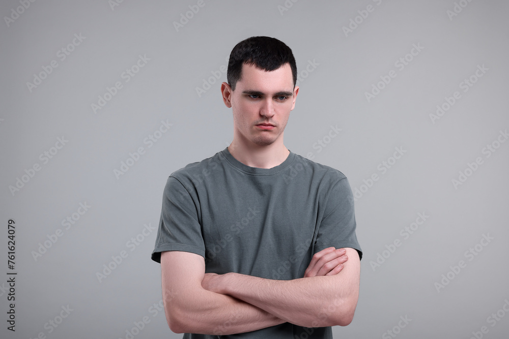 Portrait of sad man on grey background Portrait of sad man on grey background