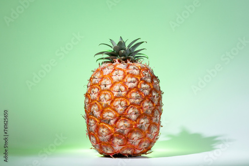 Azorean Pineapple on a green background. Fresh ripe tropical fruit. Pineapple (Ananas) fruit from Azores. photo
