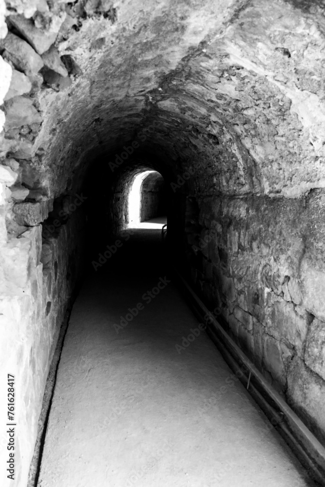 Stone tunnel with light at the end Stone tunnel with light at the end