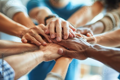 group of people holding hands, close up of diverse people joining their hands photo