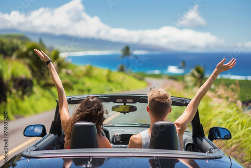 Road trip car holiday happy couple driving convertible car on summer travel Hawaii vacation. Woman with arms up having fun, young man driver (2)