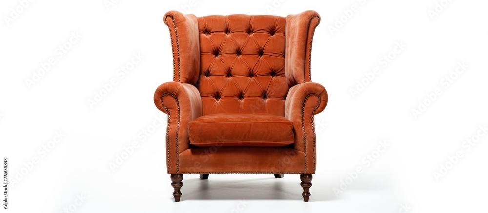 Fototapeta premium A comfortable orange leather chair with armrests sits on a white rectangular wood surface. This outdoor furniture product is made of hardwood, a natural material ideal for outdoor flooring