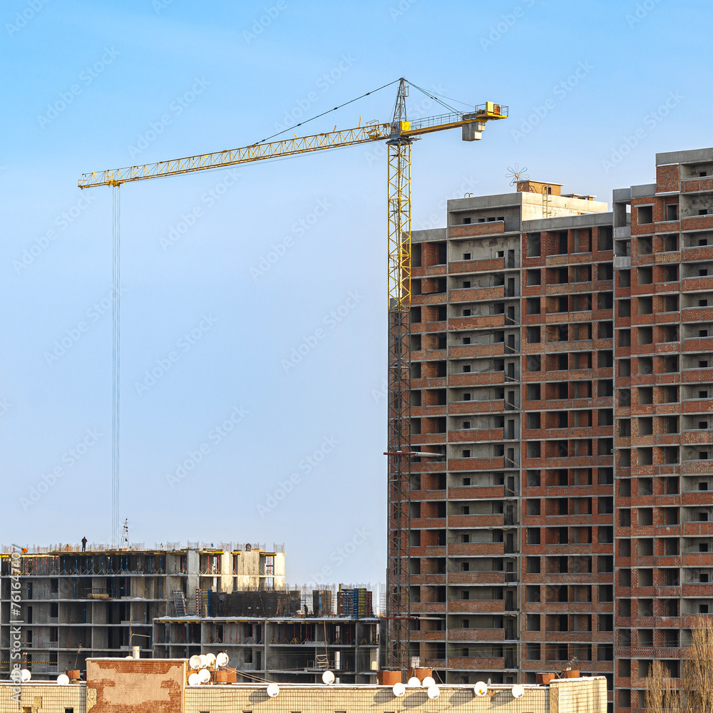 Fototapeta premium Cranes. Construction of a multi-storey residential building.