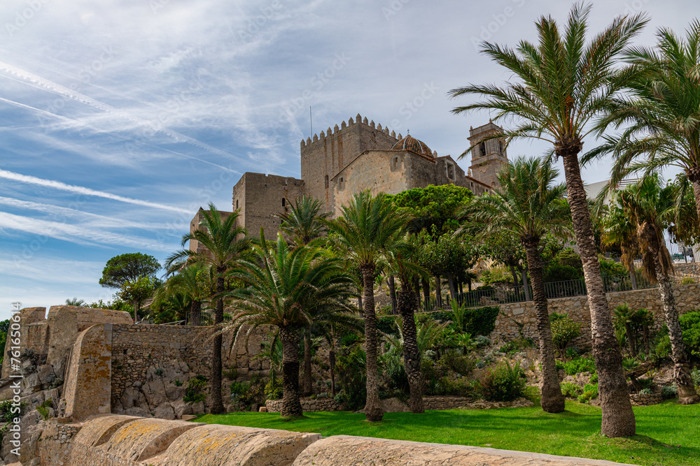 Castle in Peñiscola from the Artillery Park with some palm trees in between
