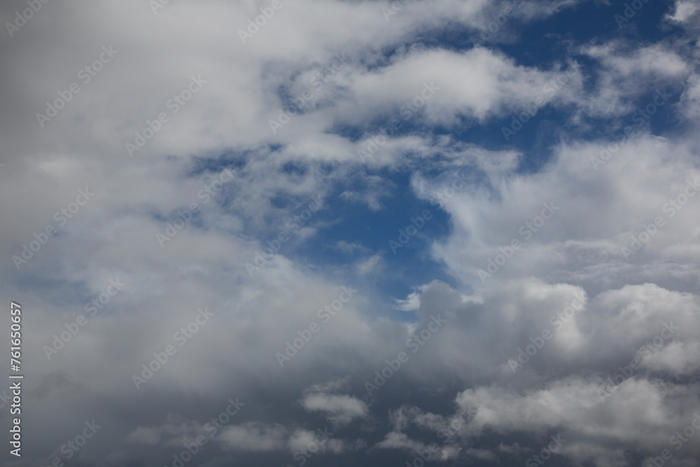 Cloudy sky with white clouds and a cloudless area with blue sky Cloudy sky with white clouds and a cloudless area with blue sky