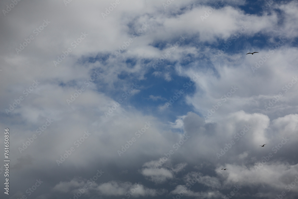 Cloudy sky with white clouds and a cloudless area with blue sky Cloudy sky with white clouds and a cloudless area with blue sky