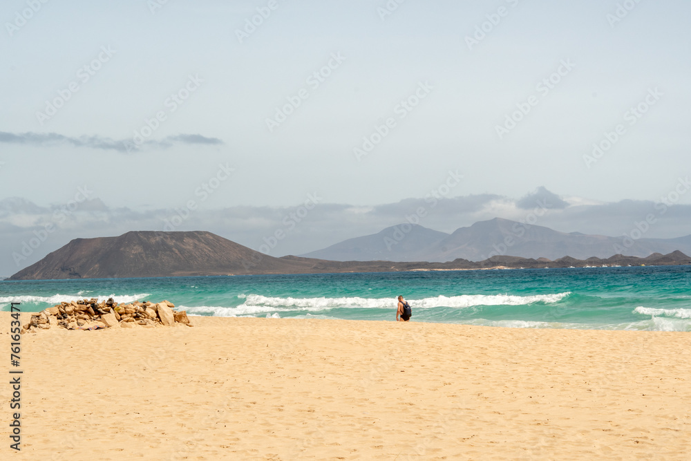 Stunning morning view of the islands of Lobos and Lanzarote seen from Corralejo Beach (Grandes Playas de Corralejo) on Fuerteventura, Canary Islands, Spain, Stunning morning view of the islands of Lobos and Lanzarote seen from Corralejo Beach (Grandes Playas de Corralejo) on Fuerteventura, Canary Islands, Spain,