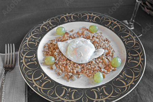 plate of crumbs with grapes and fried egg photo