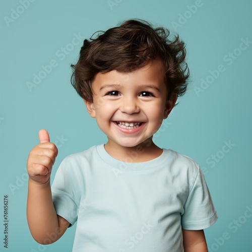 a child smiling and giving a thumbs up