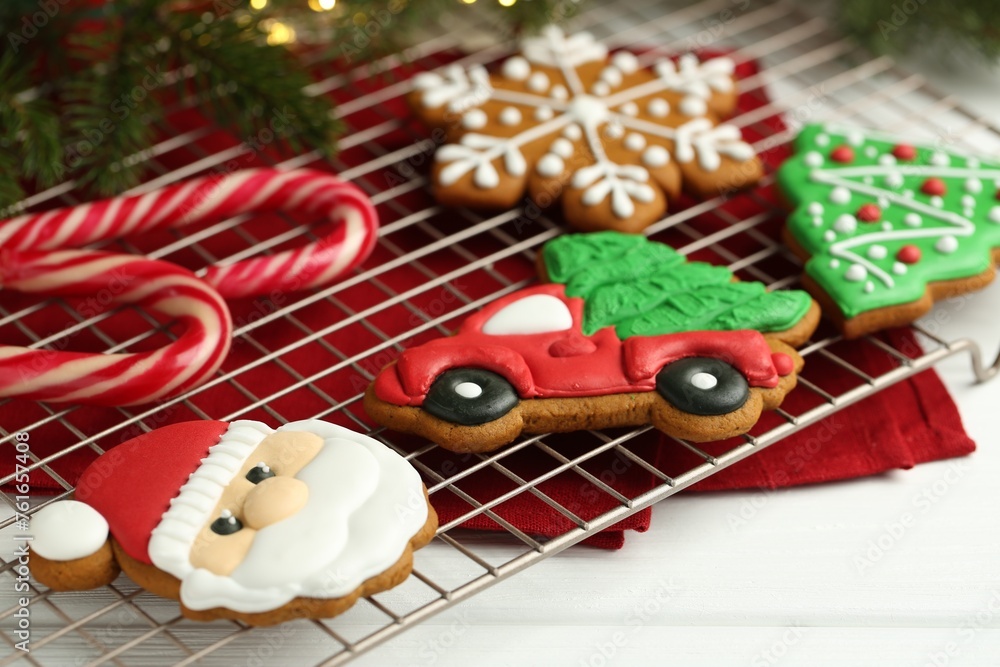 Tasty homemade Christmas cookies and candy canes on white wooden table, closeup