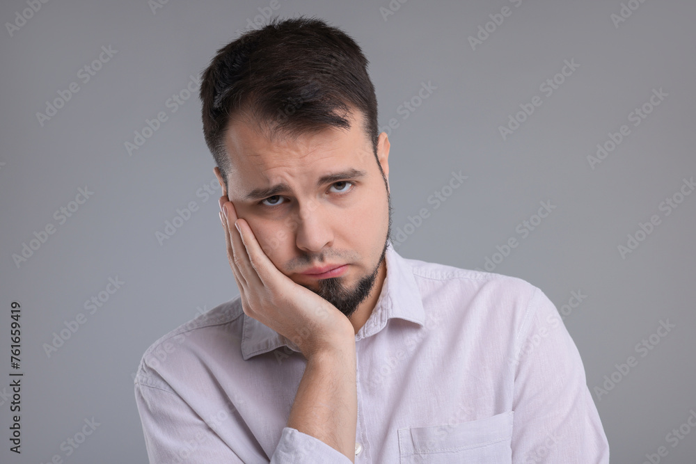 Portrait of sad man on grey background Portrait of sad man on grey background