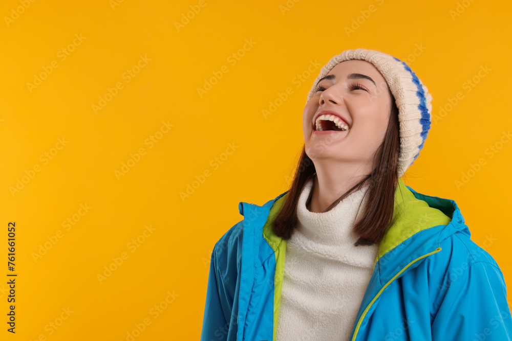 Beautiful woman laughing on orange background, space for text Beautiful woman laughing on orange background, space for text
