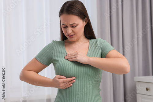 Mammology. Woman doing breast self-examination at home Free Download Mammology. Woman doing breast self-examination at home - GFXLoad