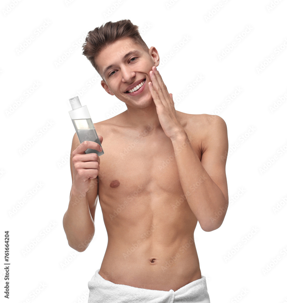 Handsome man applying lotion onto his face on white background Handsome man applying lotion onto his face on white background