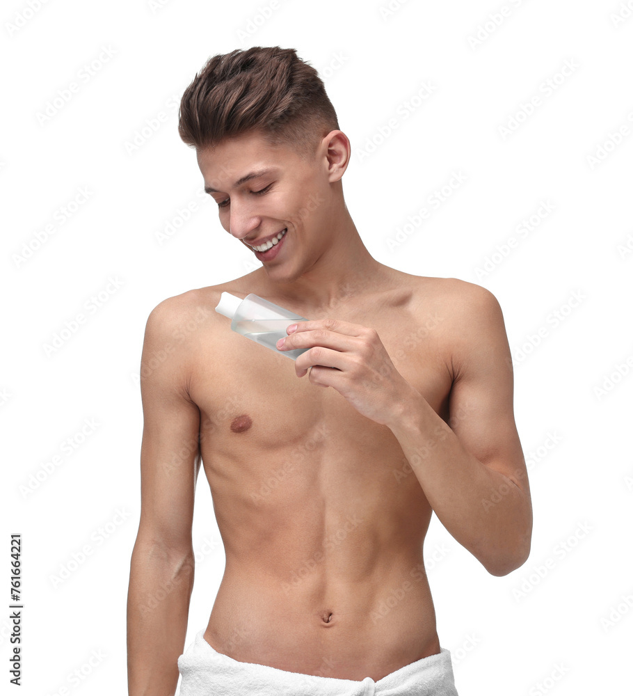 © New Africa - Handsome man applying lotion onto his body on white background