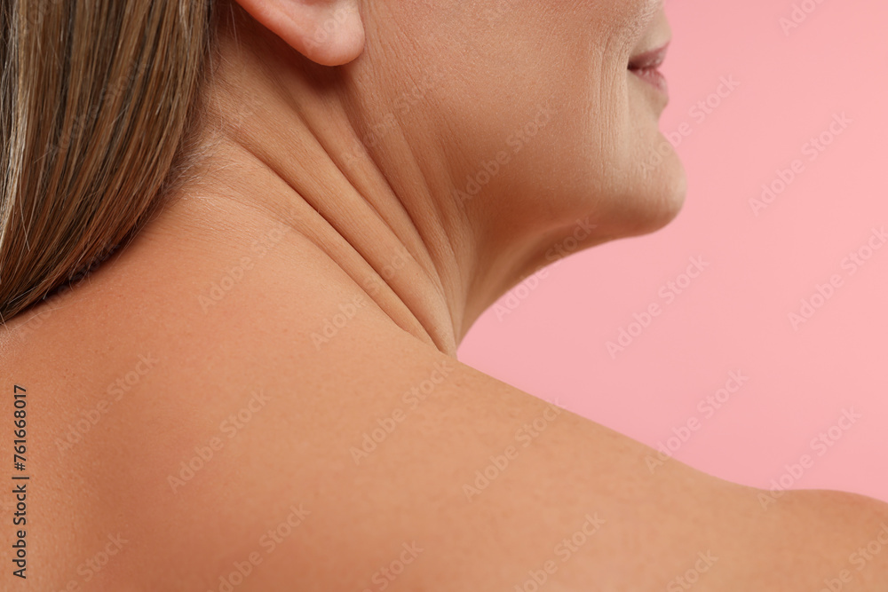 Mature woman with healthy skin on pink background, closeup Mature woman with healthy skin on pink background, closeup
