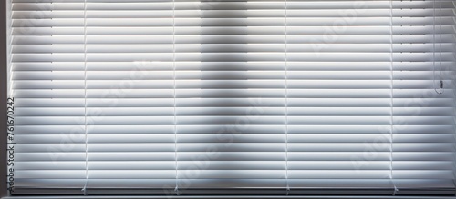 View of white horizontal window blinds from a close distance