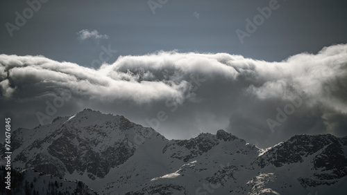 strong south wind and foehn clouds in the alps at a sunny spring day in the national park hohe tauern in austria