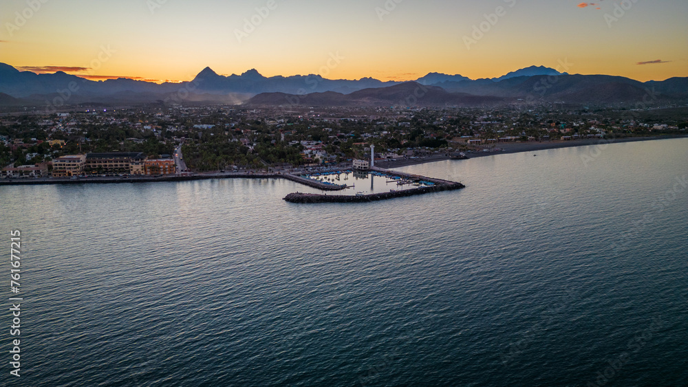 Fototapeta premium drone fly above Loreto Baja California Sur Mexico old colonial town with sea gulf ocean and mountains desert landscape at sunset