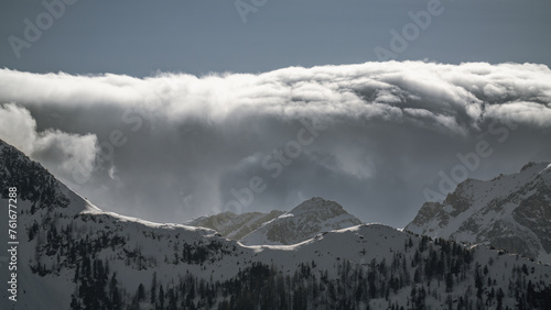 strong south wind and foehn clouds in the alps at a sunny spring day in the national park hohe tauern in austria