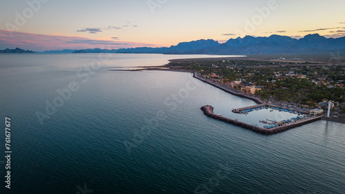 drone fly above Loreto Baja California Sur Mexico old colonial town with sea gulf ocean and mountains desert landscape at sunset