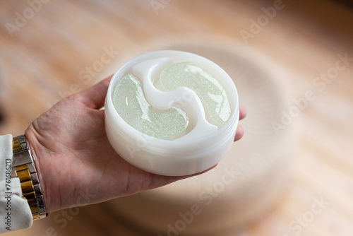 Someone is holding a white soap bar, resembling a white cream dessert. The creamy texture in their fingers looks almost like dairy ingredient for a dishware recipe