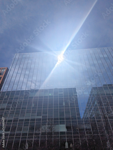Sun reflecting off of a glass-faced downtown office building