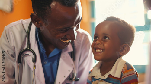 A small boy shares a joyful moment with a male doctor, highlighting the impact of care and compassion in pediatric healthcare