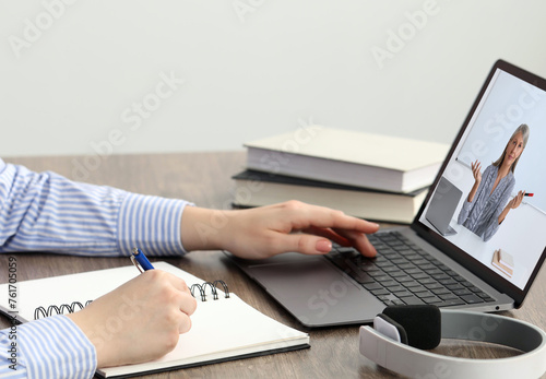 E-learning. Woman having online lesson with teacher via laptop at home, closeup