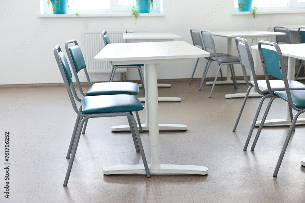 Empty school classroom with desks and chairs Empty school classroom with desks and chairs