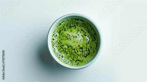 Savor the moment with our top view of a delicious matcha latte delicately crafted in a cup against a pristine white background. Enjoy the taste of tranquility