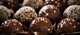 A pile of delectable chocolate truffles sits on the table, showcasing the rich flavor of this staple food ingredient in many delicious recipes