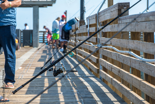 fishing rods on the dock of pier