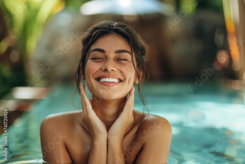 Cheerful young woman enjoys a relaxing moment in a sunny pool setting