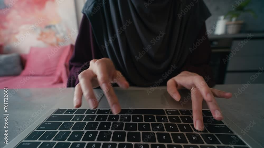 Close-up hands of Arab woman working on computer, using keyboard and touchpad Close-up hands of Arab woman working on computer, using keyboard and touchpad