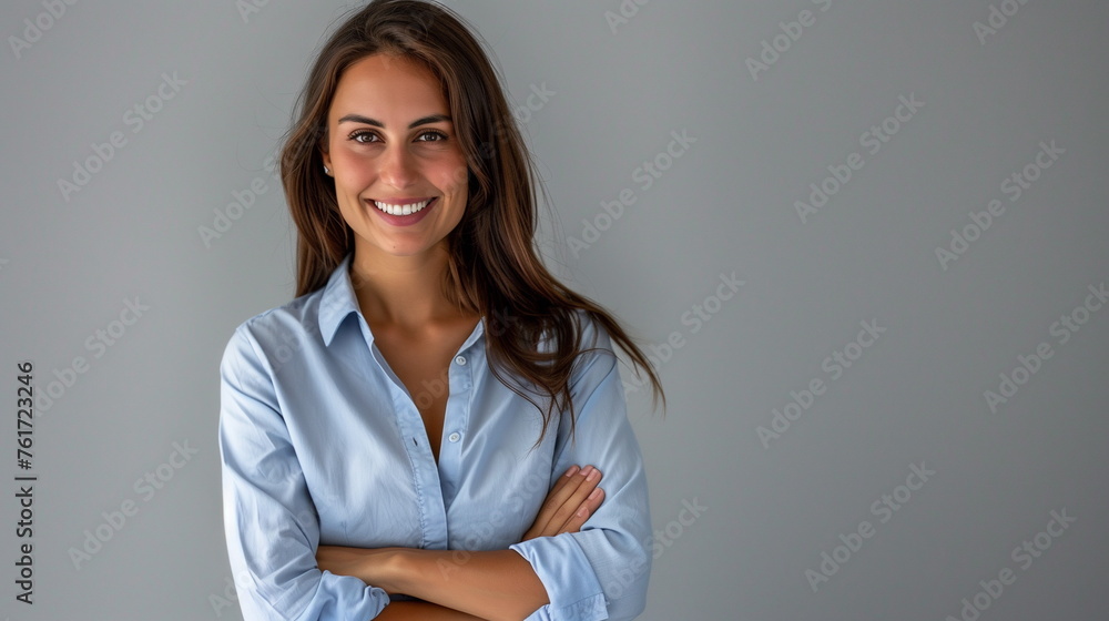 Happy young smiling confident professional business woman wearing blue shirt, happy pretty female executive looking at camera, standing arms crossed isolated at gray background, portrait. Happy young smiling confident professional business woman wearing blue shirt, happy pretty female executive looking at camera, standing arms crossed isolated at gray background, portrait.