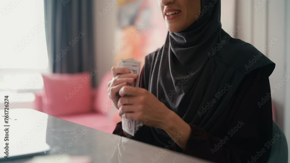 Close-up happy Arab woman counting money, saving cash to pay for dream purchase Close-up happy Arab woman counting money, saving cash to pay for dream purchase