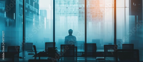 Silhouette of a person behind frosted glass in a contemporary workplace photo