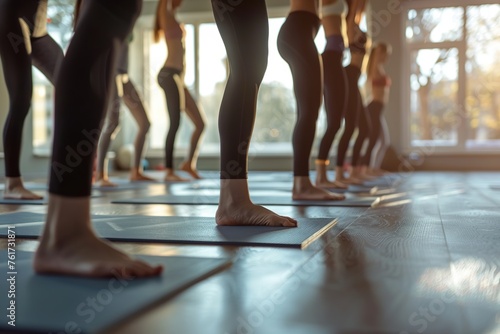 Yoga class participants engage in warrior pose fitness session