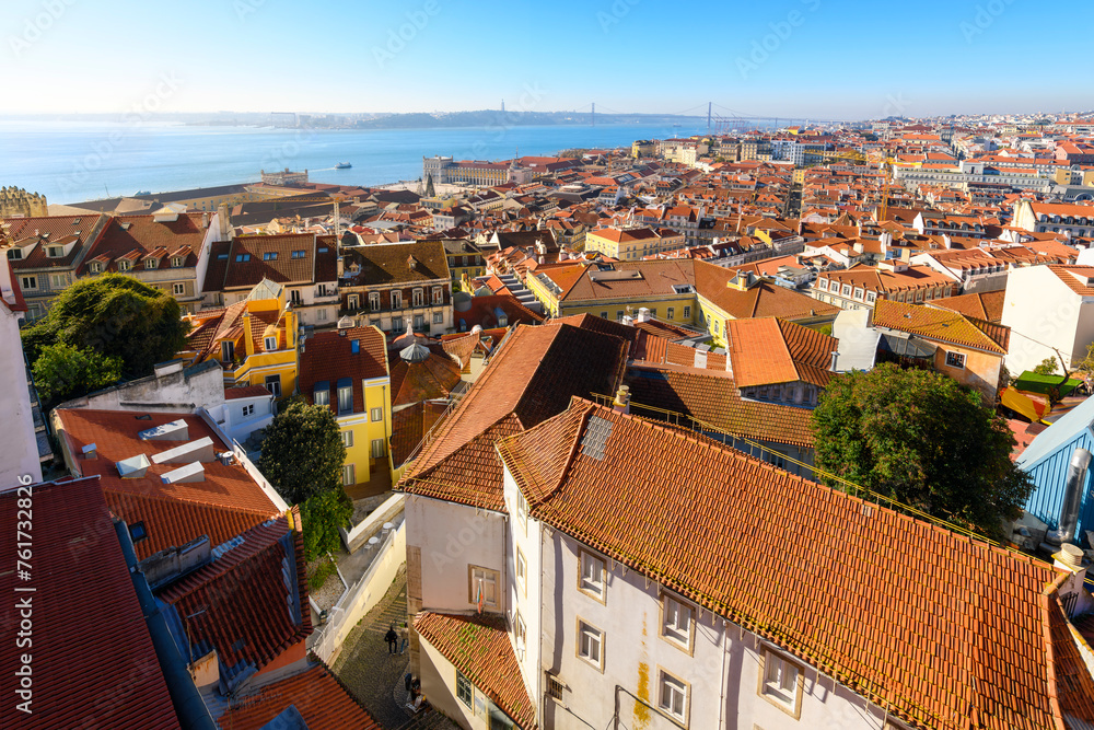 View from the top of the Alfama District looking out over the rooftops towards the Tagus River, 25 April Bridge and Praça do Comércio Square.