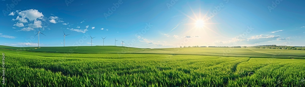 Wind turbines on green field under clear blue sky, symbolizing clean energy transition