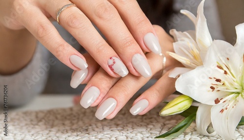 Closeup to woman hands with elegant neutral colors manicure. Beautiful manicure on long almond shaped nails. shade nail manicure with gel polish at luxury beauty salon 
