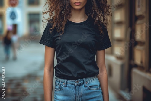 mockup of a woman wearing a black t-shirt, blurred background  photo