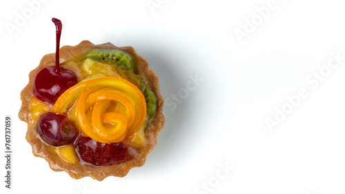 Colorful fruit cakes with kiwi, orange, candied cherry, cream and chocolate isolated on white background.
