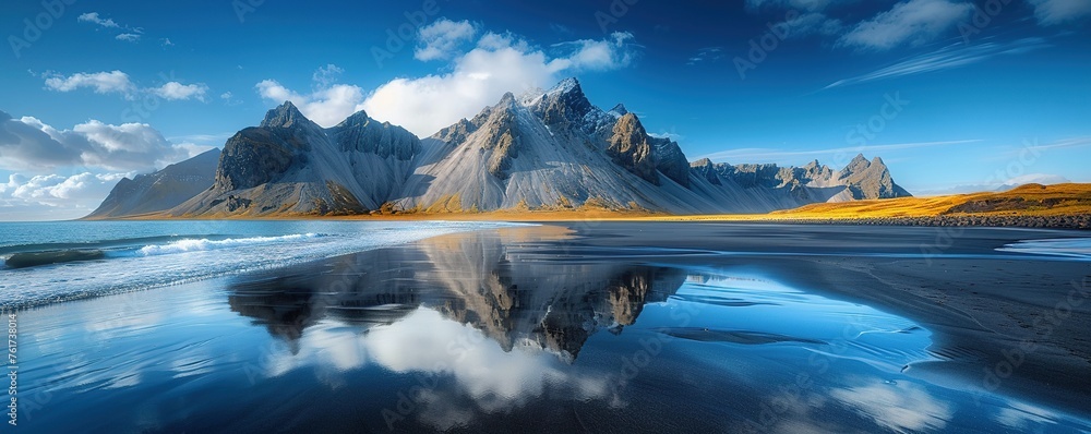 Fototapeta premium Mountains, water and black sand in Iceland.