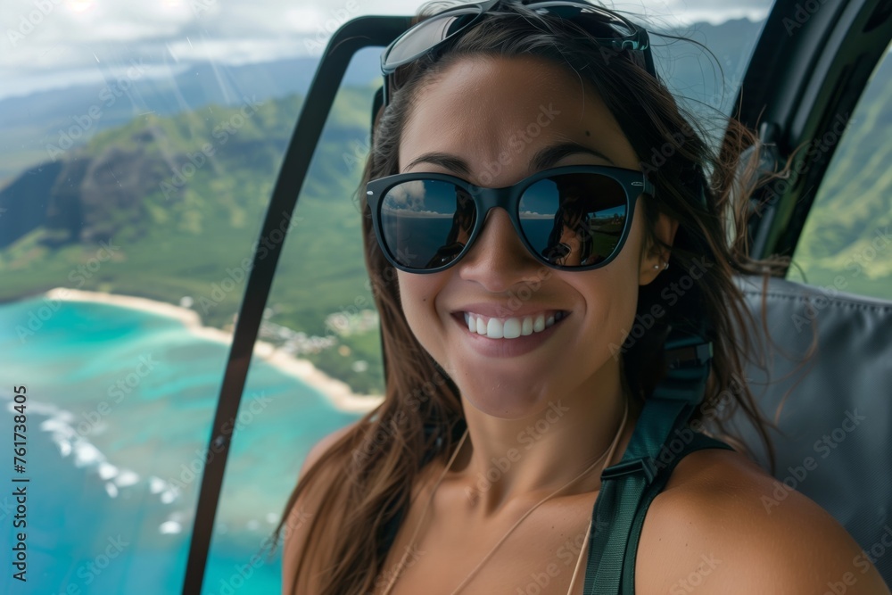 Close-up of a smiling woman enjoying a scenic helicopter ride with tropical beach reflection in sunglasses