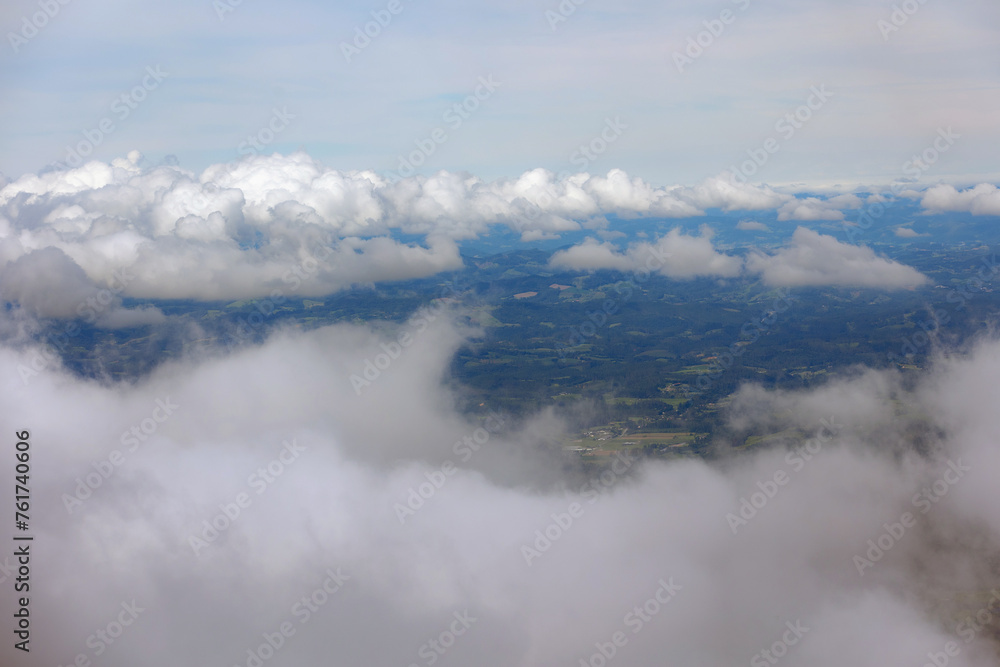 Overhead view of Serra do Rio do Rastro, showcasing clouds with glimpses of the region below nestled amidst the mountains.