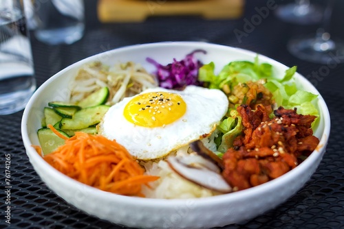 Bowl of Colourful Korean food, Tasty bibimbap, fried egg on rice, asian cuisine, healthy food